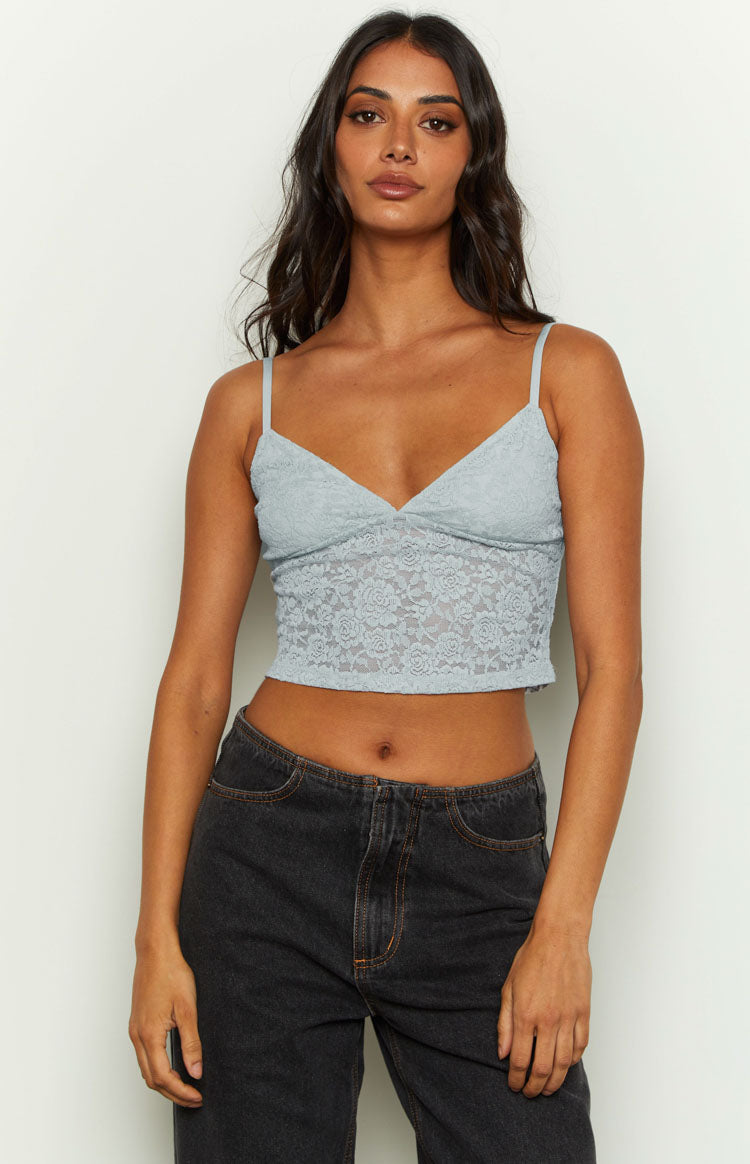 Front view of a light blue floral lace cropped cami with a V-neck and thin spaghetti straps