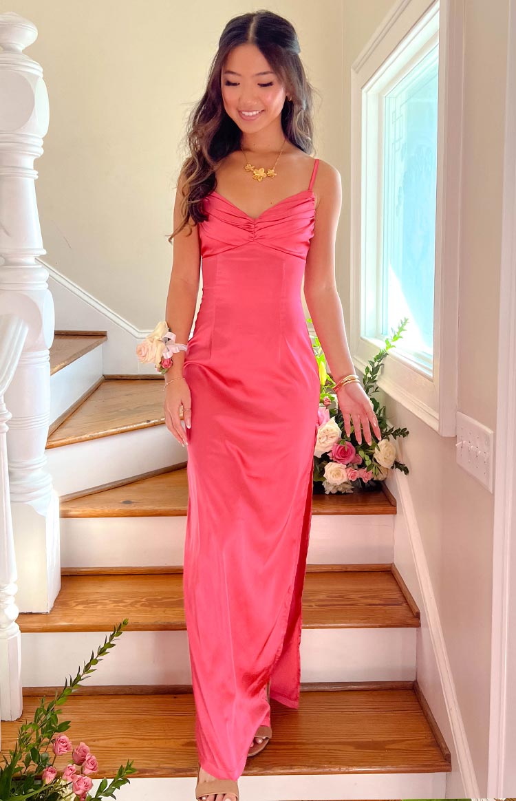 Full length view of a pink satin maxi dress with a ruched sweetheart neckline and a high side slit