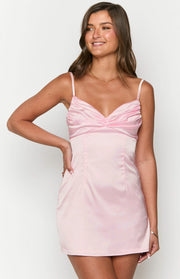 Light pink satin mini dress with a ruched sweetheart neckline and fitted bodice