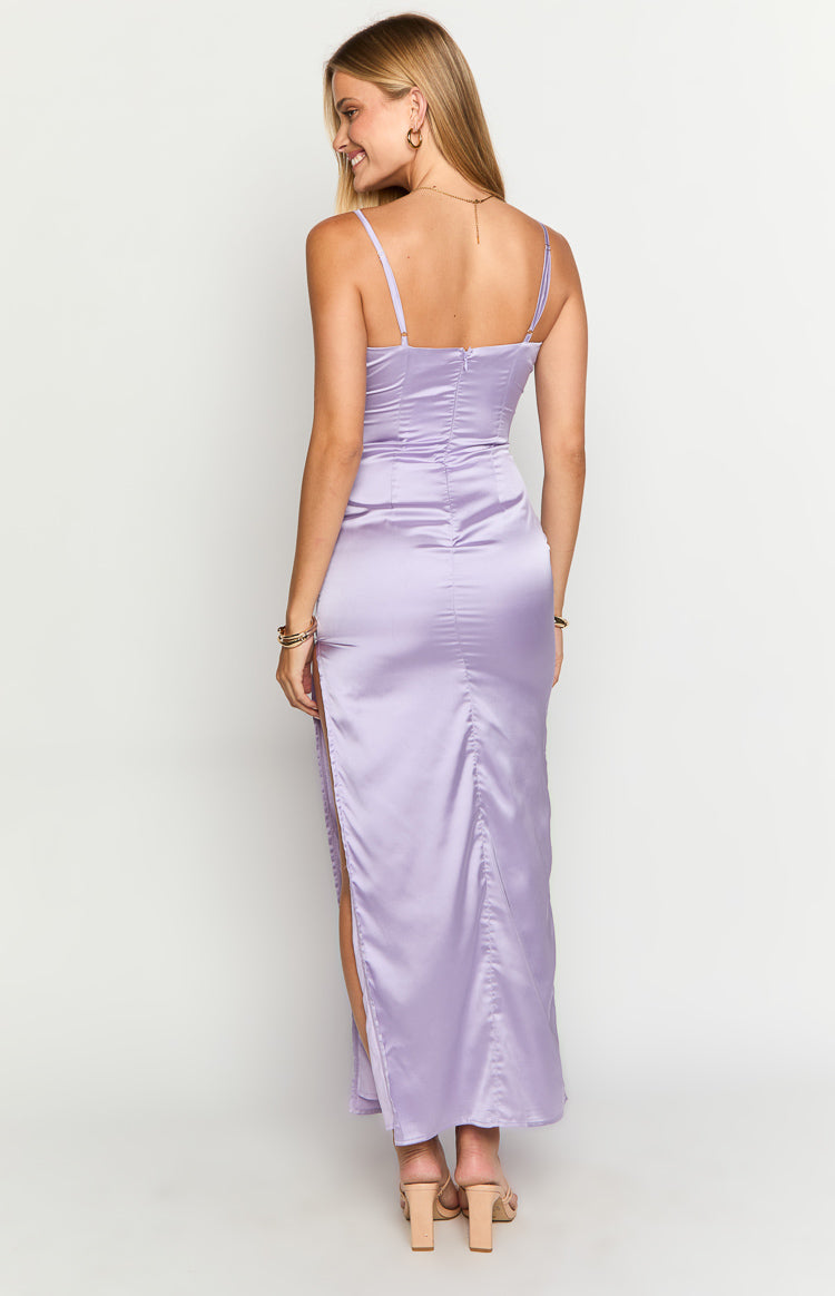 Rear view of a lilac satin maxi dress showing thin spaghetti straps, a back zipper, and a high side slit with ruched detail