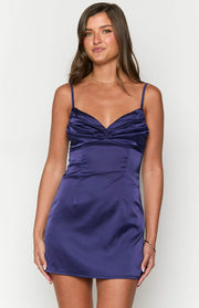 Front view of a navy satin mini dress with a ruched sweetheart neckline and thin spaghetti straps