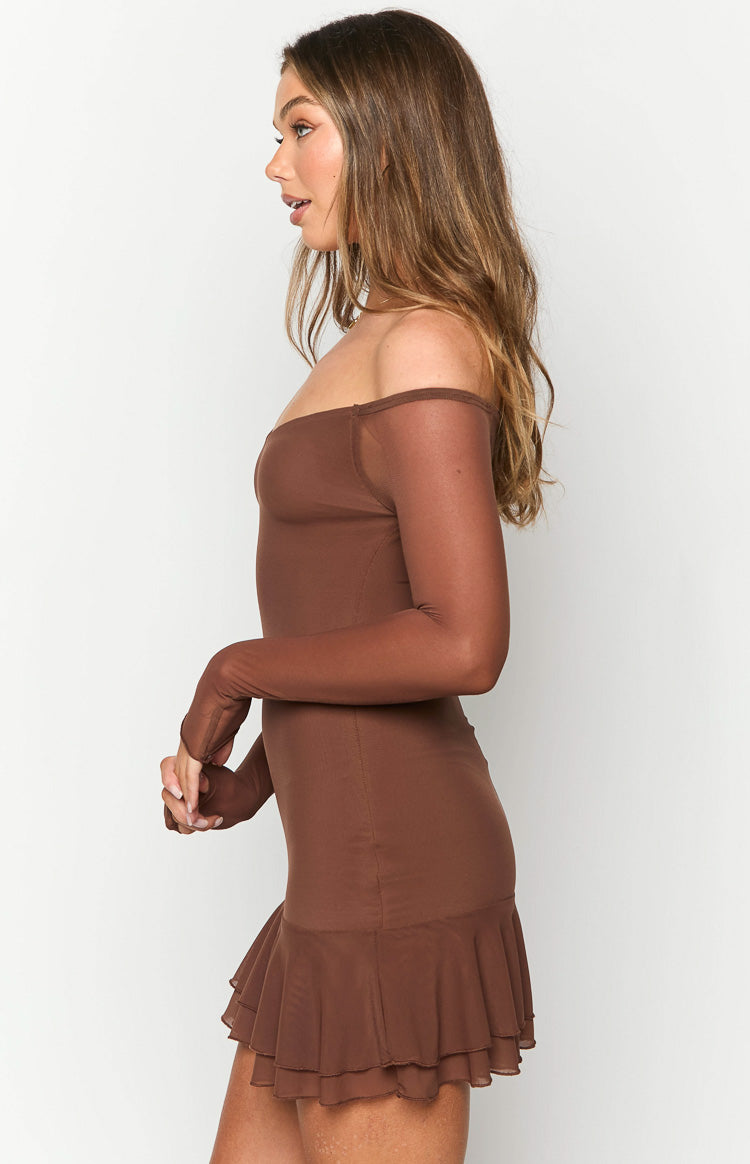 Side view of a brown off-shoulder mini dress with sheer long sleeves featuring thumbholes and a tiered ruffled hem