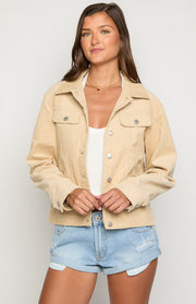 Cream corduroy western jacket with a classic collar, silver snap buttons, and two chest pockets