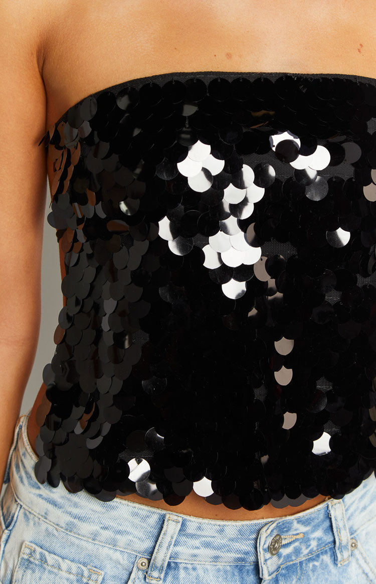 Black sequin strapless top close-up showing the texture of the overlapping sequins