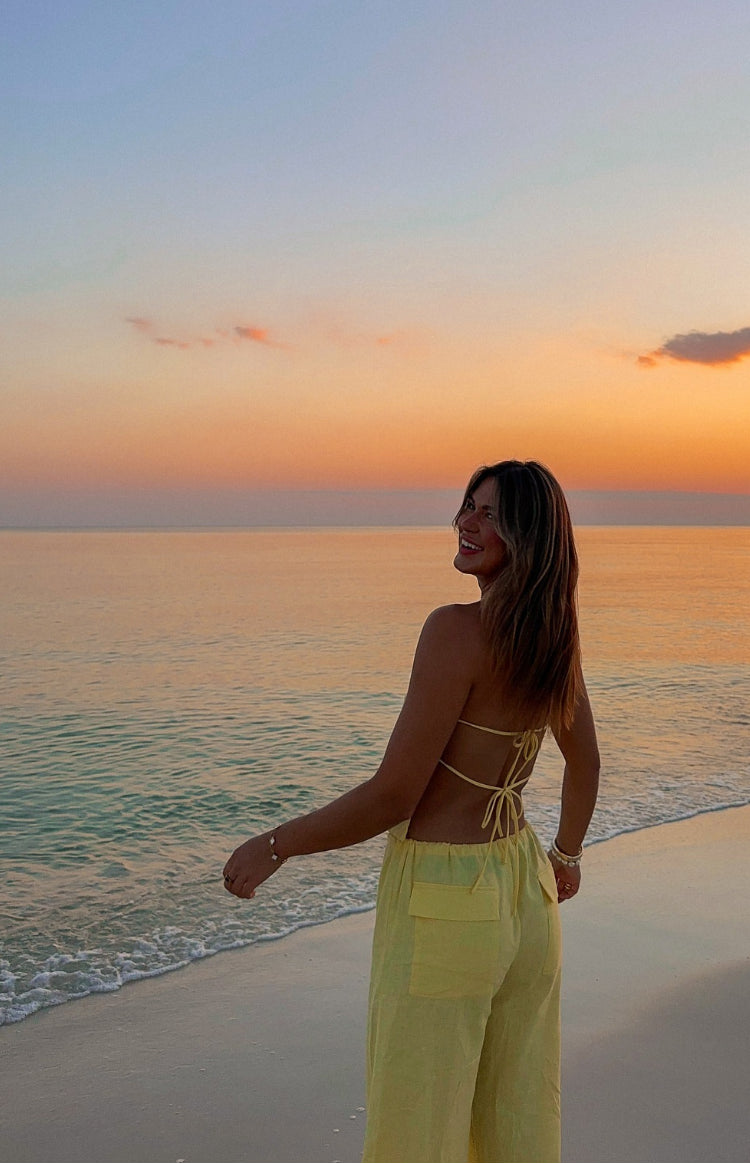 Back view of the yellow strapless top showing the criss-cross tie-back and open back