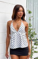 Beginning Boutique Imee White Polka Dot Top white polka dot halter top with deep V-neck, gathered waist, and side ties