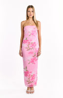 A light pink strapless maxi-dress with a ruched bodice and a flowing skirt- featuring a vibrant pink and green floral pattern. This dress is suitable for a beach wedding or a vacation.