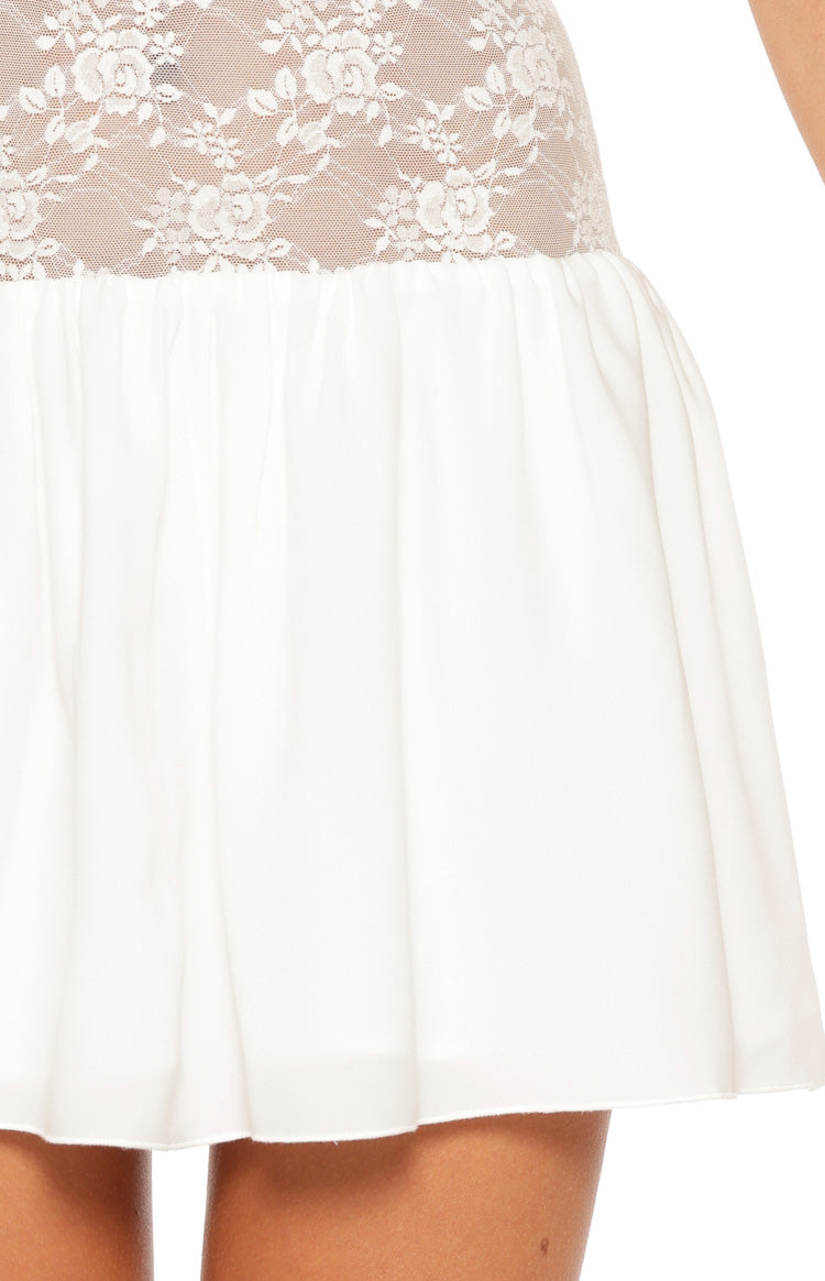 Close-up of the white floral lace bodice transitioning to the gathered waist and flowy mini skirt