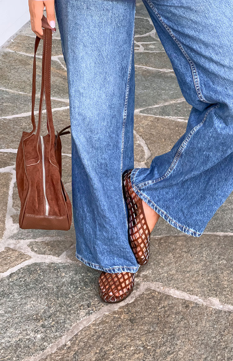 Angled view of brown jelly ballet flats featuring a woven lattice pattern and rounded toe