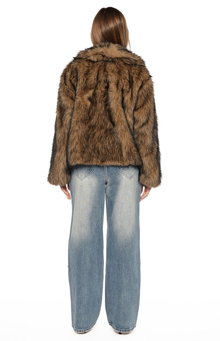 Rear view of a chocolate brown faux fur jacket with a relaxed fit and shaggy texture