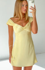 Close-up of a yellow satin mini dress with a ruched sweetheart neckline and off-shoulder puff sleeves