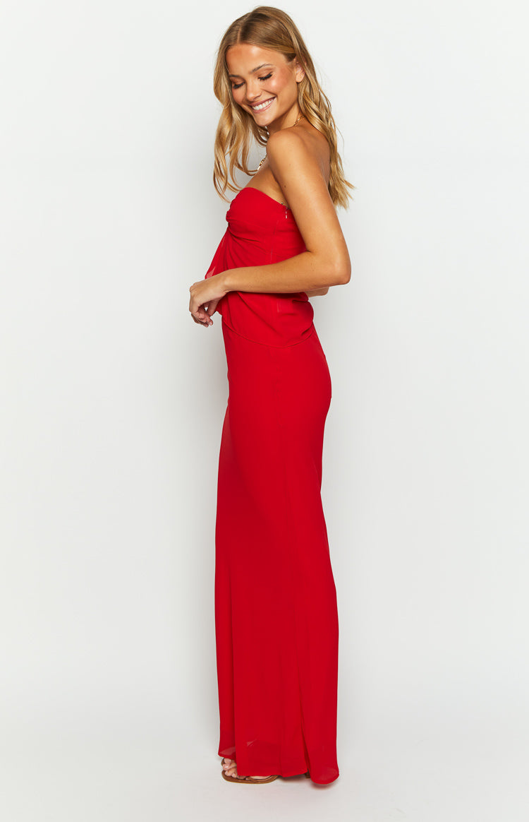 Side view of a red maxi skirt, showing the fitted waist and hips flowing into a long, straight hem