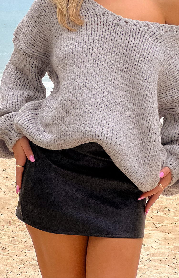 Close-up of the black PU pebbled mini skirt, highlighting its textured finish and straight hem