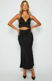 Black satin V-neck crop top with thin spaghetti straps, a ruffled hem, and delicate lace trim