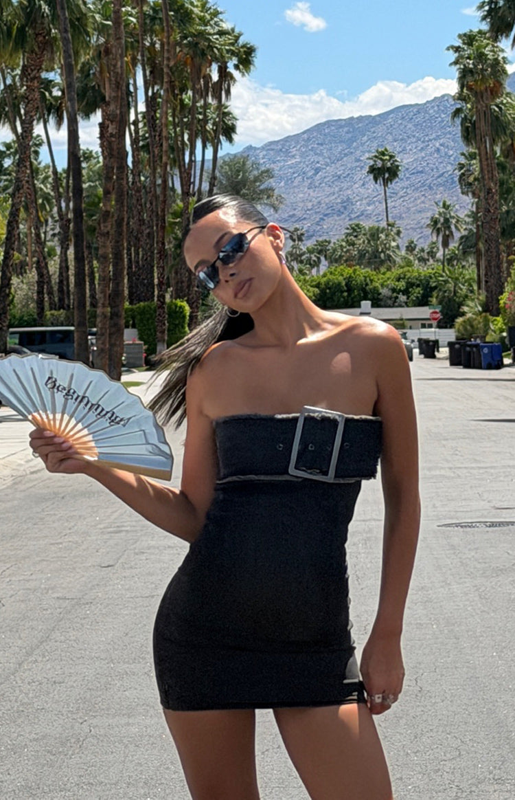 stretch black denim dress with large buckle on the streets of palm springs