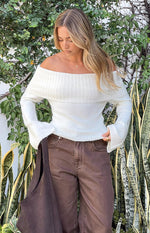 Cream off-shoulder sweater with a wide ribbed fold-over neckline and long flared cuffs