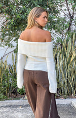 Rear view of a cream off shoulder sweater with a wide ribbed neckline and fuzzy knit texture