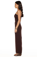 Side view of a brown crepe strapless maxi dress with a fitted ruched bodice and straight skirt with a side slit