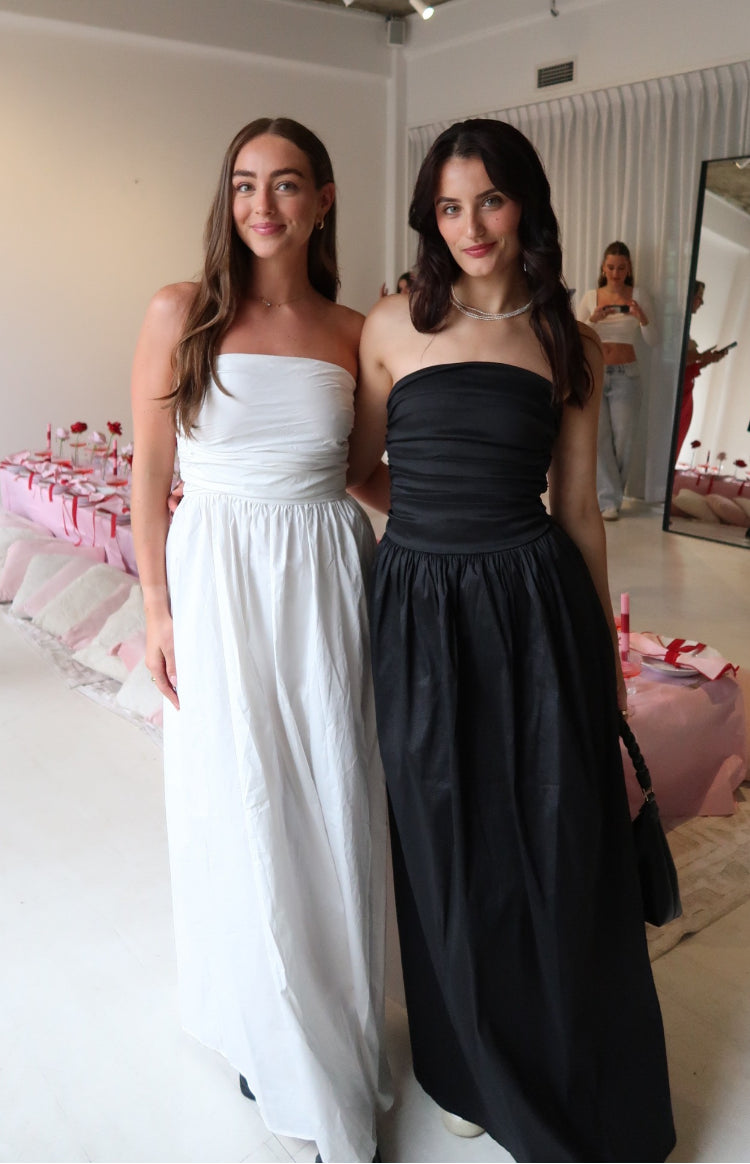 White strapless maxi dress with a ruched bandeau bodice and a full, flowing skirt