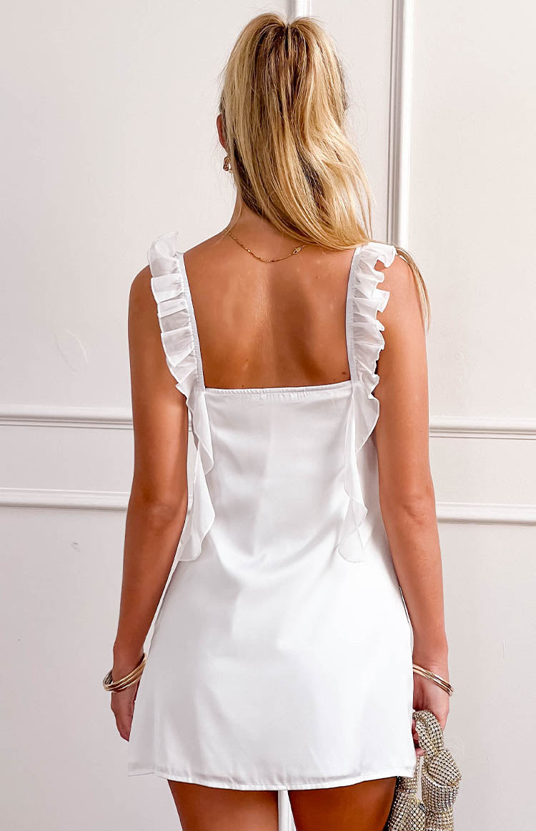 Rear view of a white satin mini dress with ruffled shoulder straps and a square back neckline