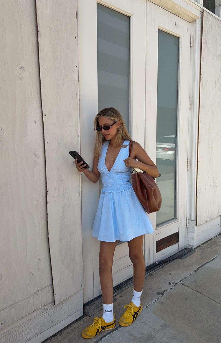 Light blue stripe mini dress with a deep V-neckline, shirred bodice, and a flowy A-line skirt