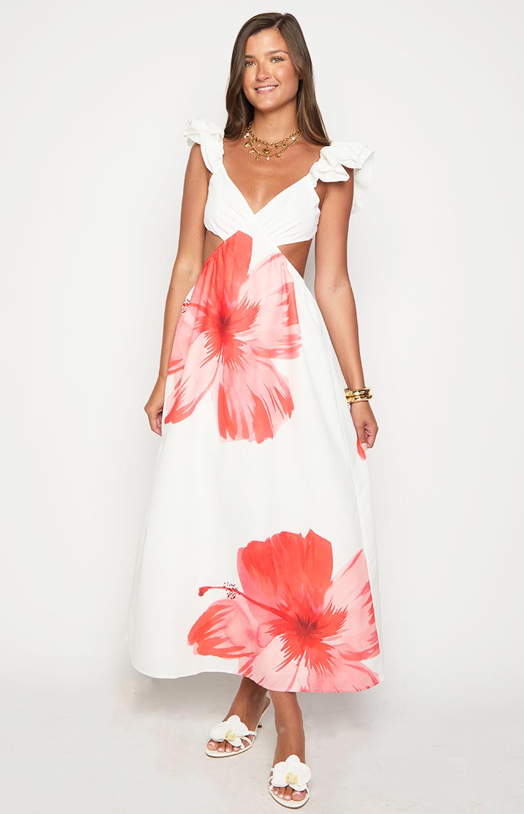 Front view of a white maxi dress with a ruched V-neck bodice, ruffled cap sleeves, side waist cutouts, and red floral print