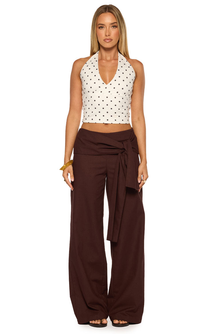 Front view of brown linen wide-leg pants with a large tie-front detail at the waist