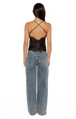 Rear view showing the criss-cross spaghetti straps and low scoop back of a black satin cami top