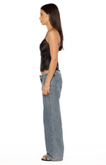 Side view of a black satin cami top with thin spaghetti straps and lace trim along the hem