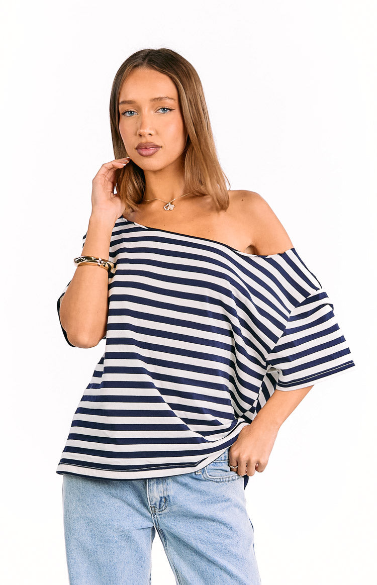 Navy and white striped off-shoulder top with a wide neckline and relaxed, oversized fit