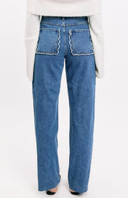 Rear view of mid-wash denim jeans with white scallop trim on the back patch pockets
