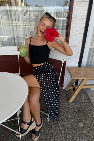 Beginning Boutique Khalea Black Polka Dot Hanky Hem Midi Skirt black and white polka dot flowy midi skirt with hanky hem and