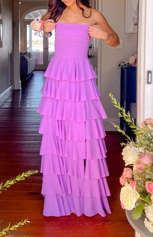 Girl wearing a purple strapless tiered formal gown for prom