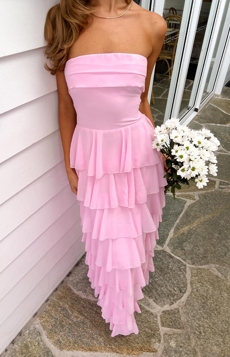 A long- baby pink strapless gown with a fitted bodice and a skirt composed of numerous cascading ruffles- offering a romantic and elegant look.