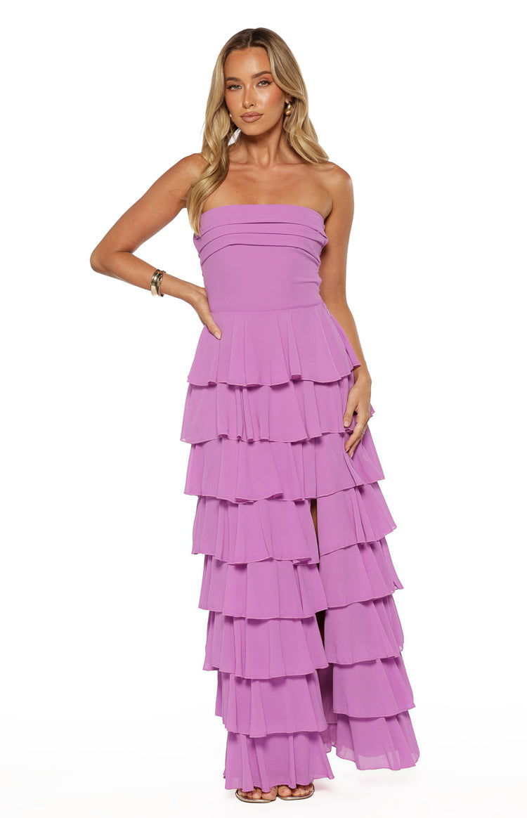 Magenta strapless maxi dress with a pleated bodice, full tiered ruffles, and a high leg split