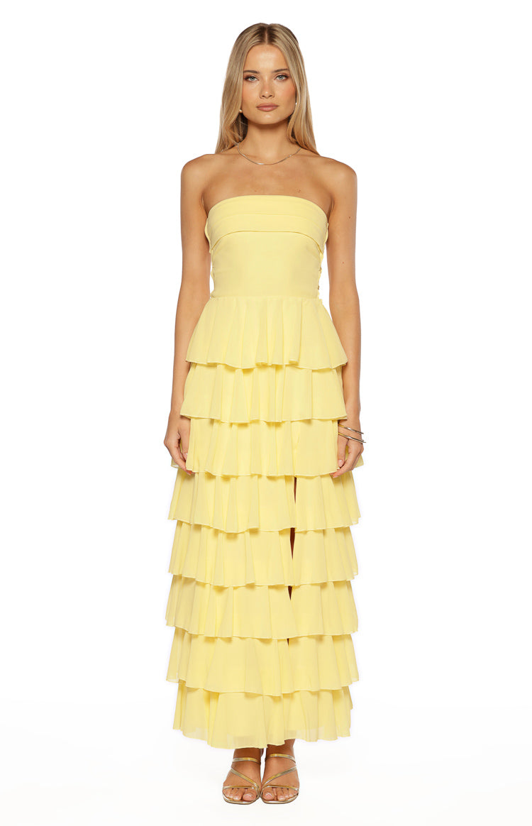 Front view of a yellow strapless maxi dress with a fitted bodice and full tiered ruffle skirt