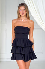 Black strapless mini dress with horizontal pleats on the bodice and a three-tiered ruffle skirt