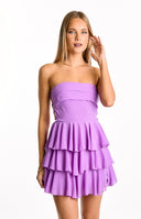 A bright magenta strapless mini dress with a fitted- pleated bodice and multiple tiers of playful ruffles forming the skirt- suitable for a lively party or homecoming.