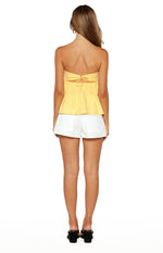 Rear view of the yellow strapless top showing the tie-back detail and cut-out waist