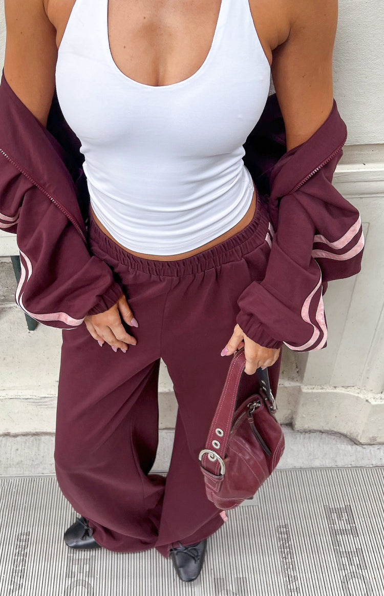 Burgundy wide-leg track pants with an elasticated waistband and relaxed fit
