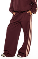 Beginning Boutique Kosie Burgundy and Pink Stripe Track Pants burgundy wide-leg track pants with double pink side stripes