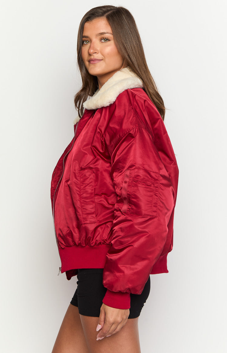 Side view of a mulberry puffer jacket with a cream faux fur collar, ribbed cuffs, and hem