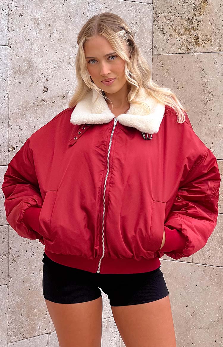 Mulberry puffer jacket with a white faux fur collar, silver zipper, and ribbed cuffs