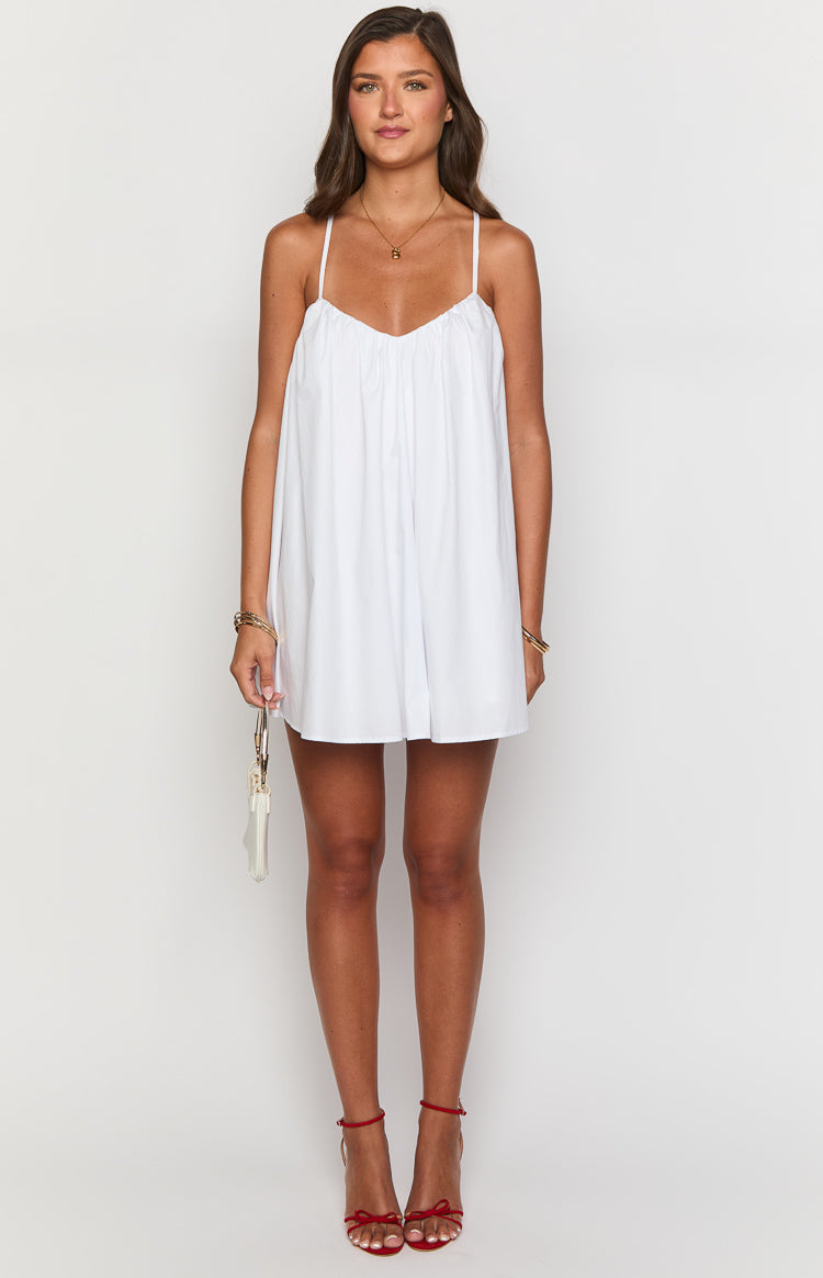 White mini dress with a gathered V-neck bust, thin spaghetti straps, and a loose A-line silhouette