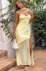 Yellow satin maxi dress with a sweetheart neckline, thin straps, a neck scarf, and a sheer skirt with a high slit