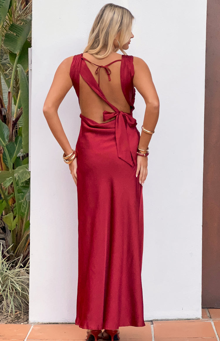 Rear view of a wine satin maxi dress featuring a deep open back, thin neck tie, and wide waist tie