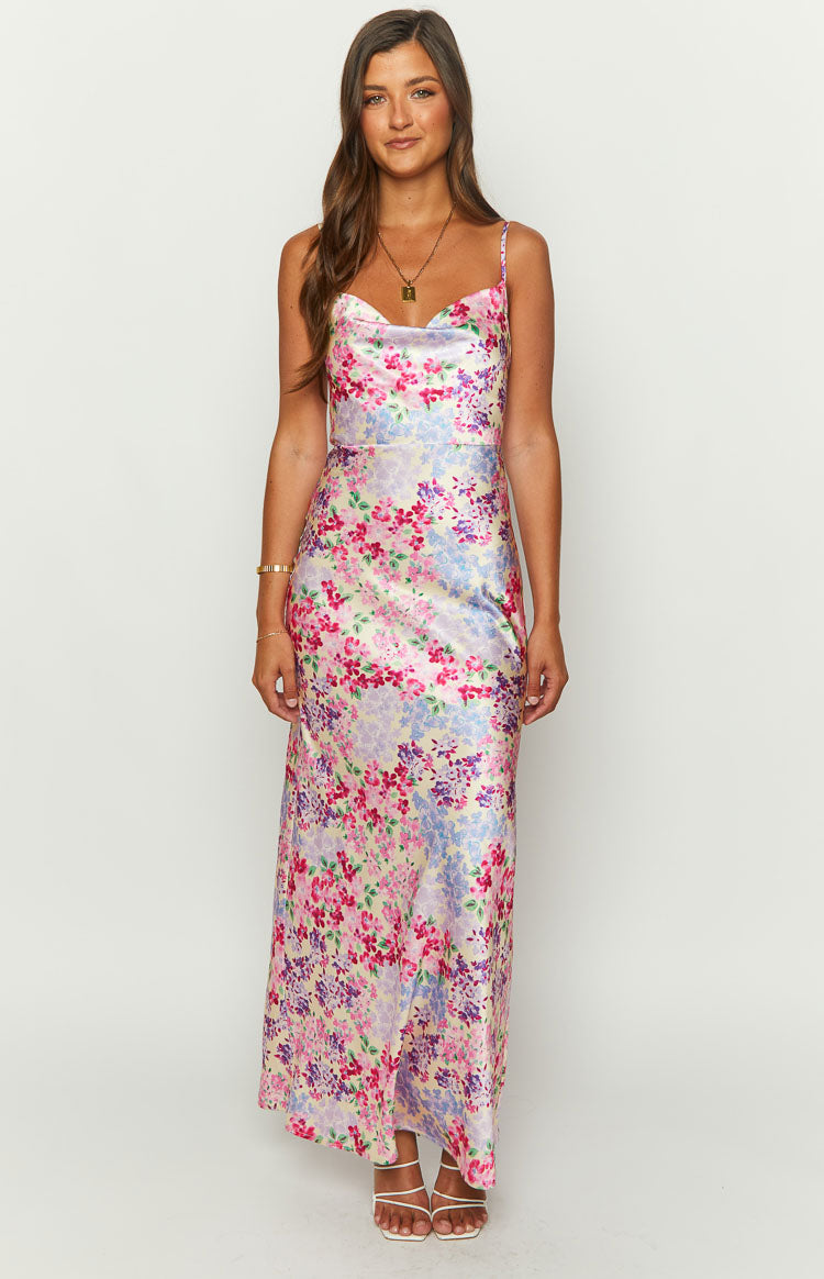Yellow floral satin maxi dress with a draped cowl neck, delicate spaghetti straps, and a fitted waist