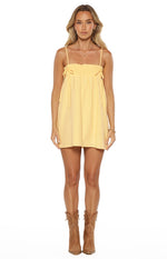 Yellow mini dress with a shirred bust, thin spaghetti straps, and decorative tie details at the sides