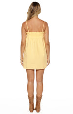 Back view of a yellow mini dress showing the shirred elasticated top edge and thin adjustable spaghetti straps