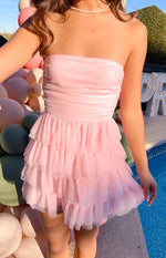 Lower front view of the pink mini dress with a ruched strapless bodice and a voluminous three-tiered tulle skirt